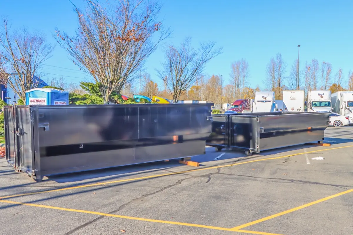 Professional dumpster rental service with roll-off container on residential driveway in Watervliet